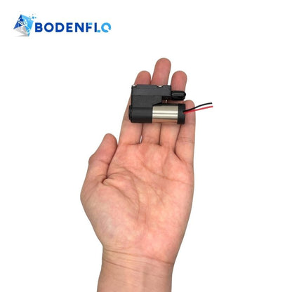 Handheld view of BD-05T02.53000 micro diaphragm pump showing compact size and lightweight design